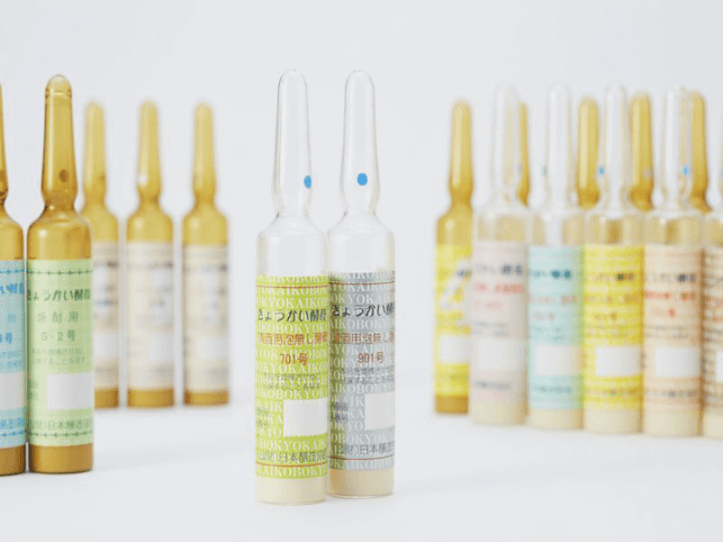 Colorful ampules of sake yeast on a white backdrop.