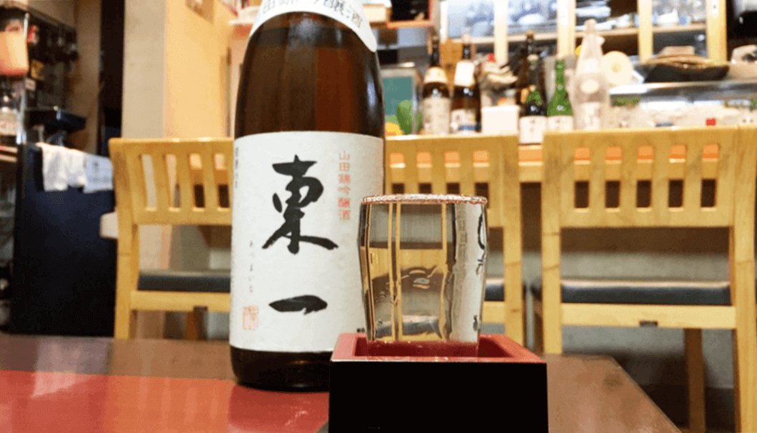 bottle of "Azumaichi" sake served into a glass and "masu" box