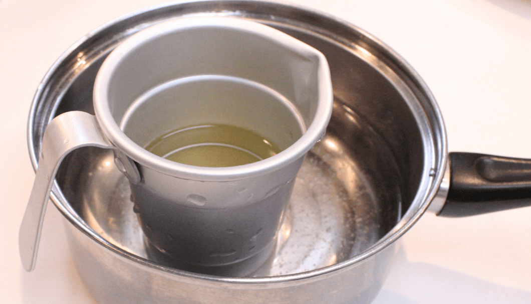 A chirori of sake heating up in a pot of boiled water